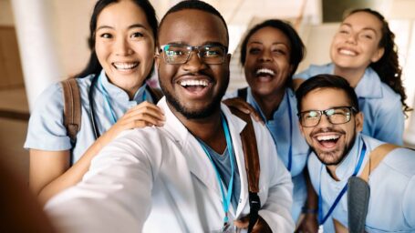 Multi-ethnic group of happy students having fun wile taking selfie at medical university.